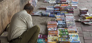 A view of a bookseller setting up stall in Daryaganj