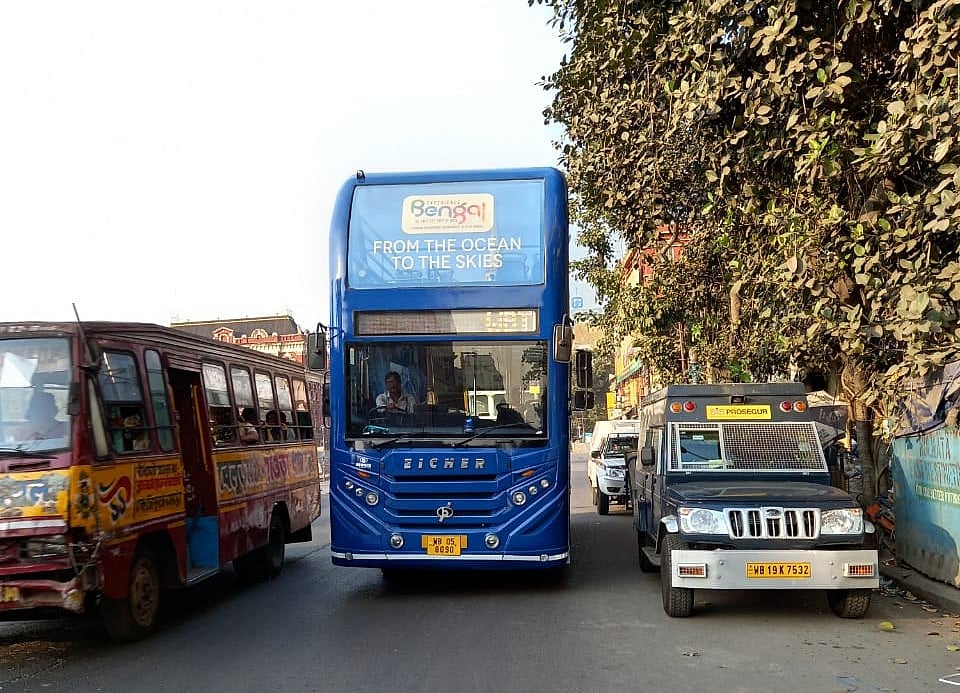 The double decker bus has an open-air upper deck