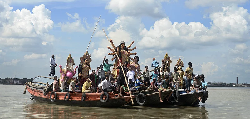 Durga idols being transported on boats on the Hooghly river