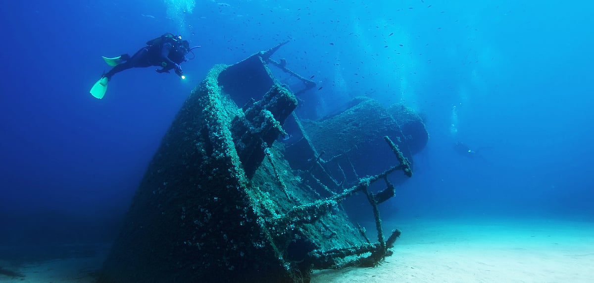 A diver exploring an old sunken ship
