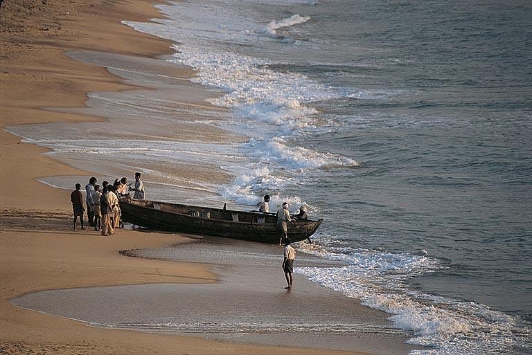 A fisherman pulls his boat shorewards after a days hard work