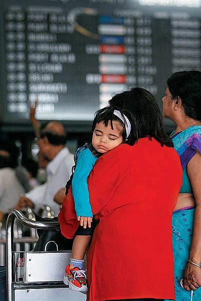 Mother carrying a child outside airport
