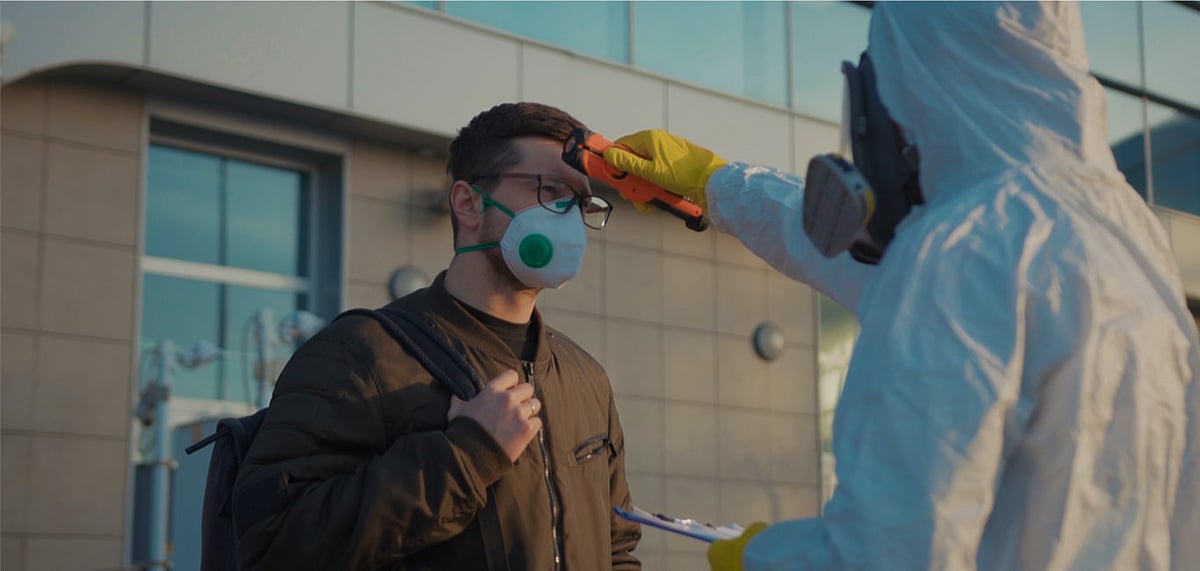 Representative image A medical worker screens passengers