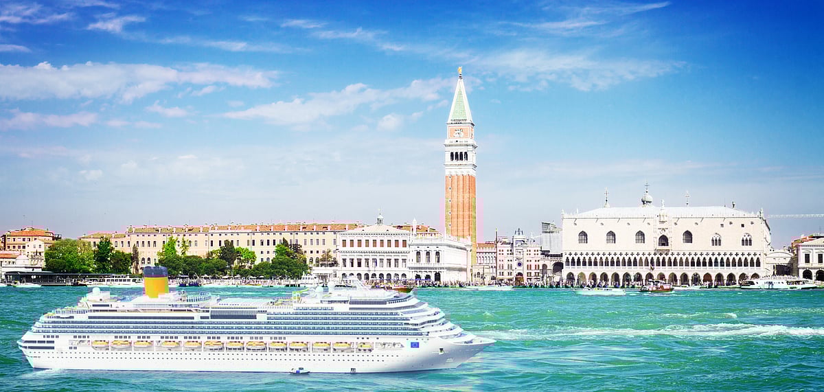 A cruise ships sailing through the lagoon overlooked by St Marks Square