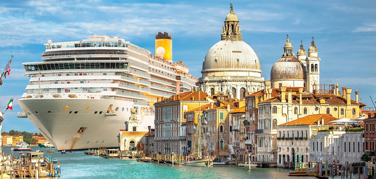 A hulking cruise ship towers over Venice