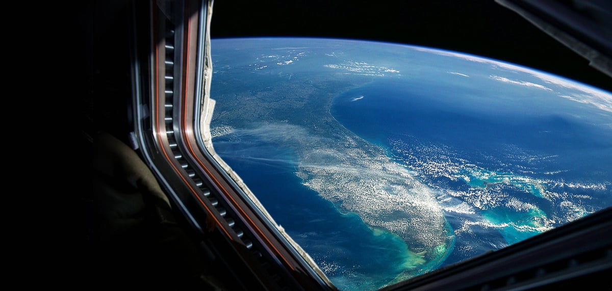 Spaceship flies near the amazing blue planet earth, view from the window