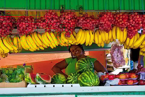 A fruit vendor poses in Scarborough