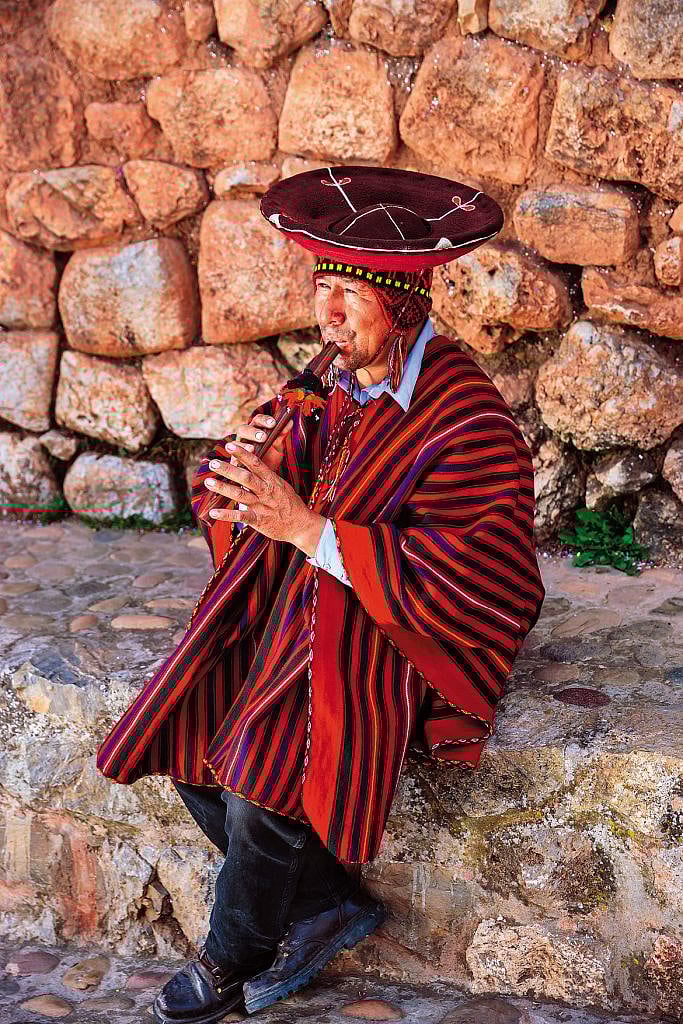 A Peruvian man plays a soothing melody on the flute