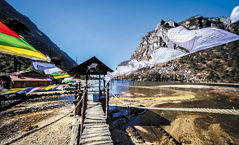 Amid blue waters and green-brown mountains