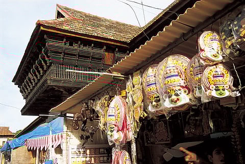 Kathakali masks lined up at a stall