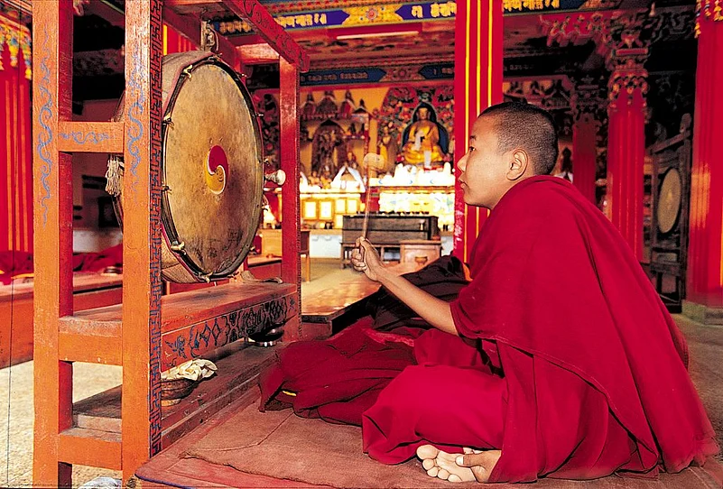 A monk ringing the gong at a monastery in Kalimpong