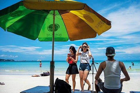 Tourists on Boracay's legendary White Beach