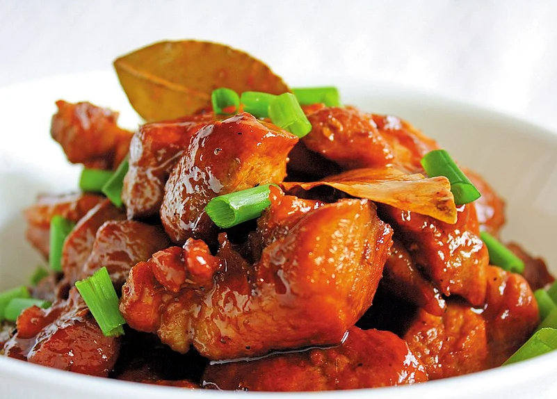 Bite into pork belly adobo