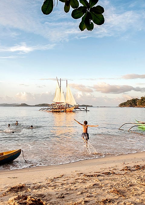 A girl enjoys sailing in a paraw