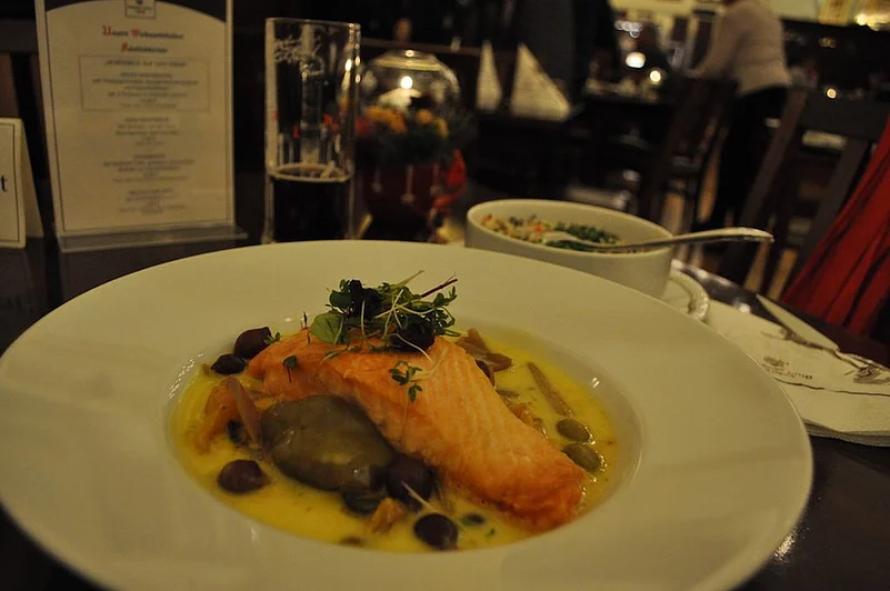 Braised Salmon Fillet with vegetables and red wine onions in Leipzig