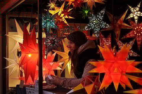 Woman negotiating with customer while selling Christmas lights