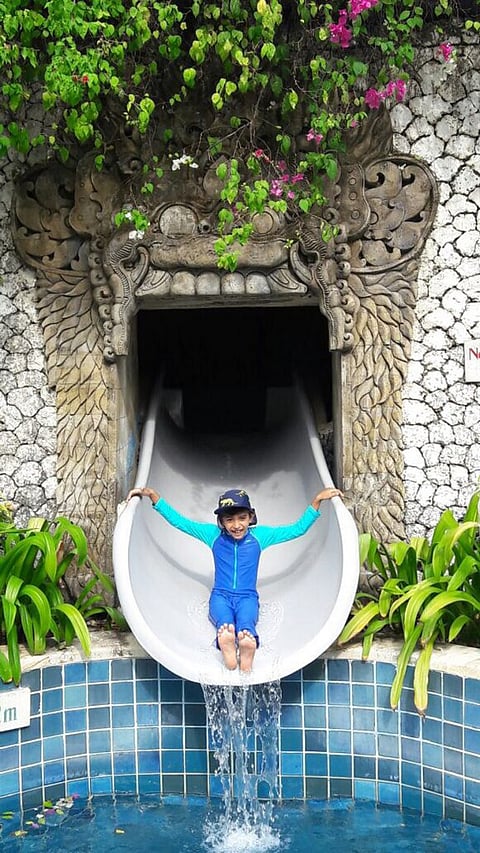 My child on a water slide