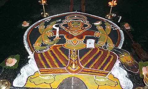 An elaborate pookalam representing a Kathakali dance