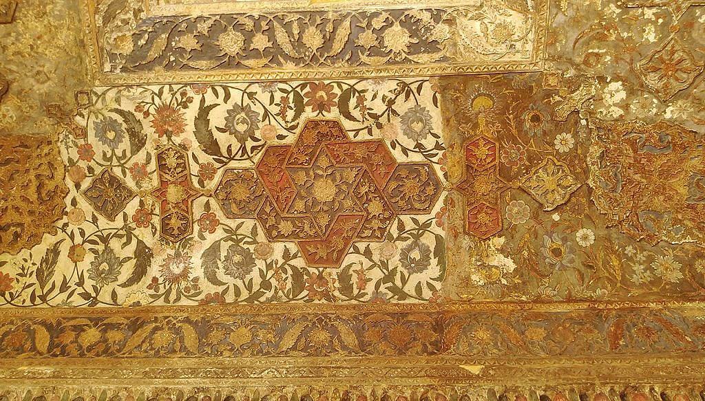 An intricately carved painted ceiling inside the tomb