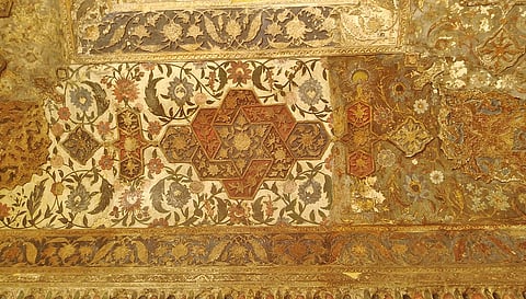 An intricately carved painted ceiling inside the tomb