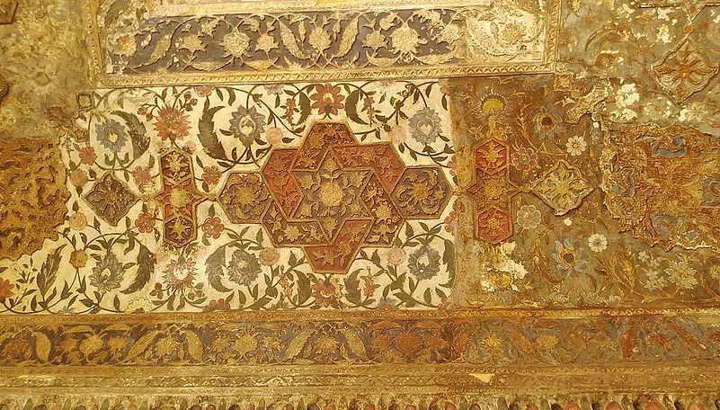An intricately carved painted ceiling inside the tomb