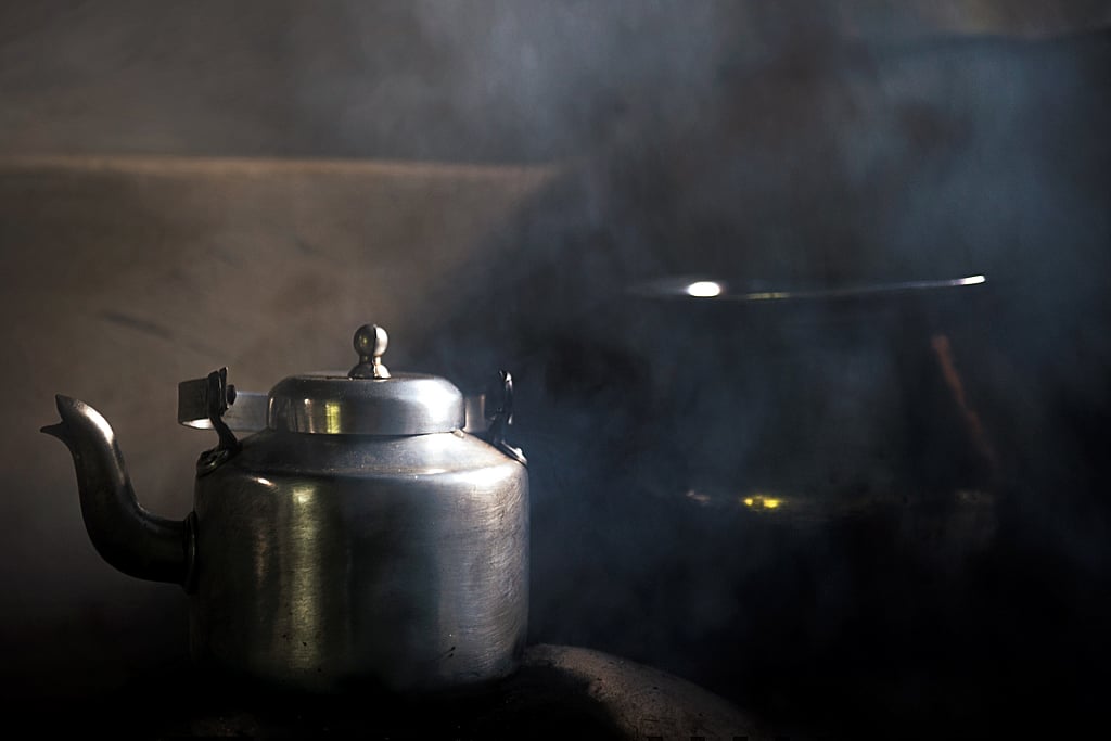 Tea brews over a wood-fired stove