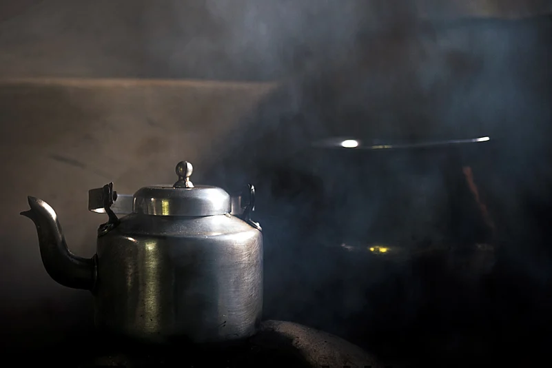Tea brews over a wood-fired stove