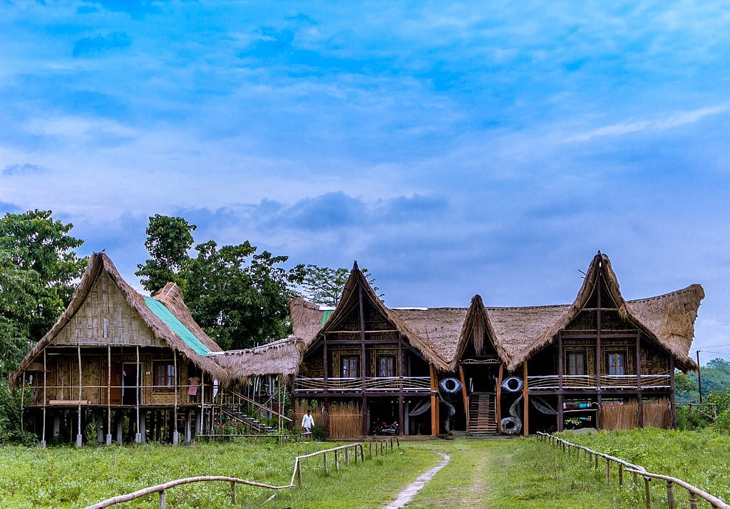 Bamboo cottages on river island Majuli