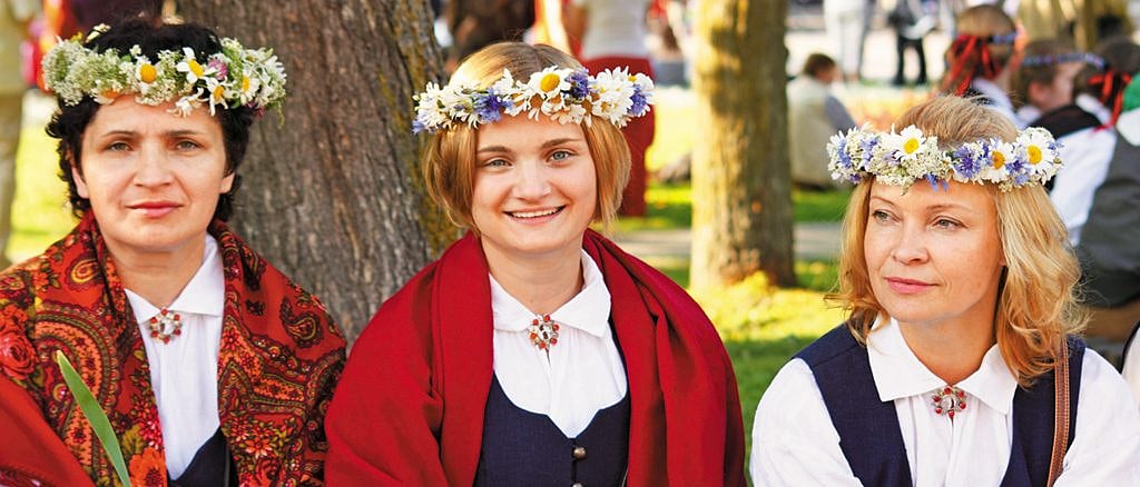 Women adorn their heads with floral crows for the celebrations