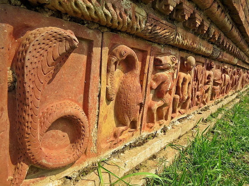 The terracotta statues on the walls of the Somapura University take inspiration from Hinduism, Buddhism, and Jainism