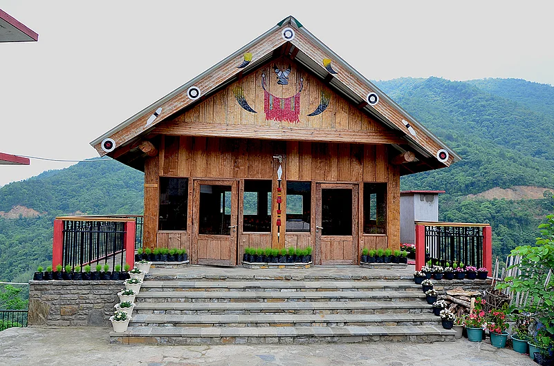 The sitting room with verdant forest for a backdrop