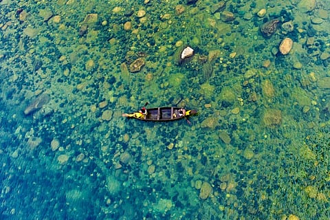 An aerial view of a fishing boat on Umngot River