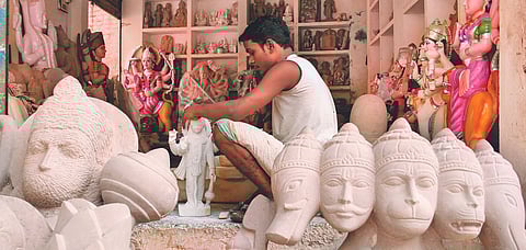 A sculptor makes stone idols in Chitrakoot