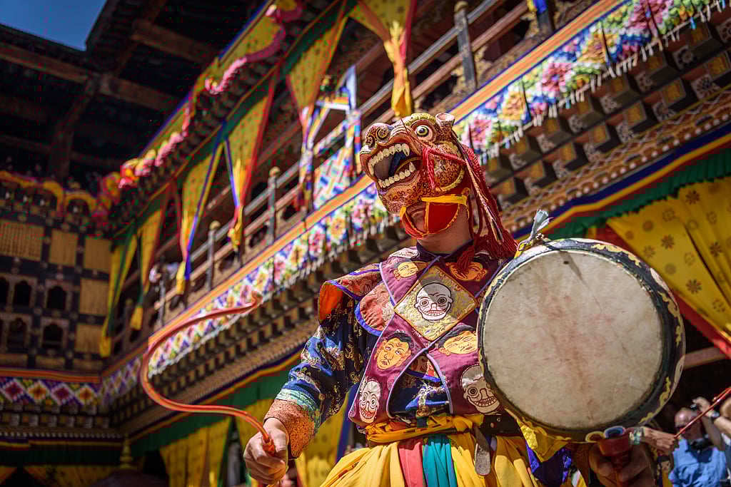 A Buddhist monk performing a traditional dance in Bhutan