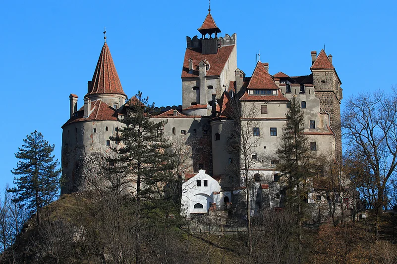 Bran Castle sits atop a tall rocky hill in the Carpathian Mountains of Transylvania