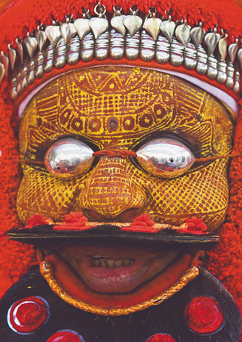 Theyyam dancer in South India dressed as a local deity called Mutthappan