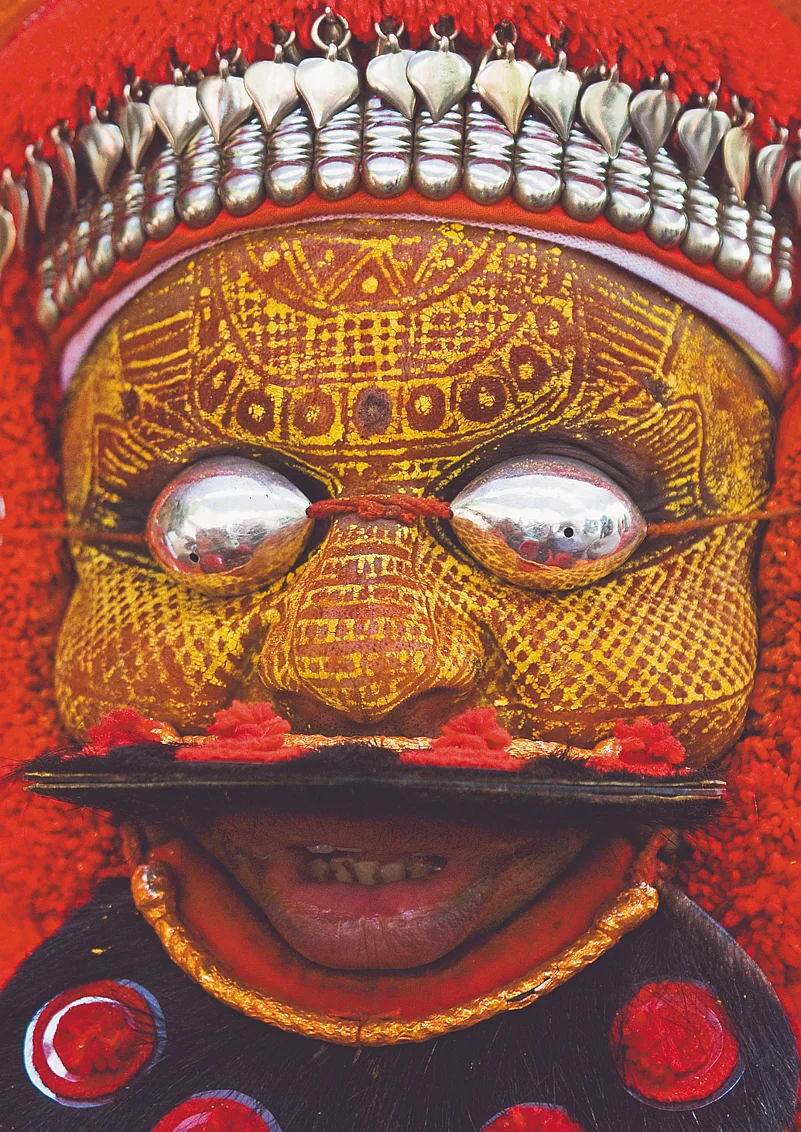 Theyyam dancer in South India dressed as a local deity called Mutthappan