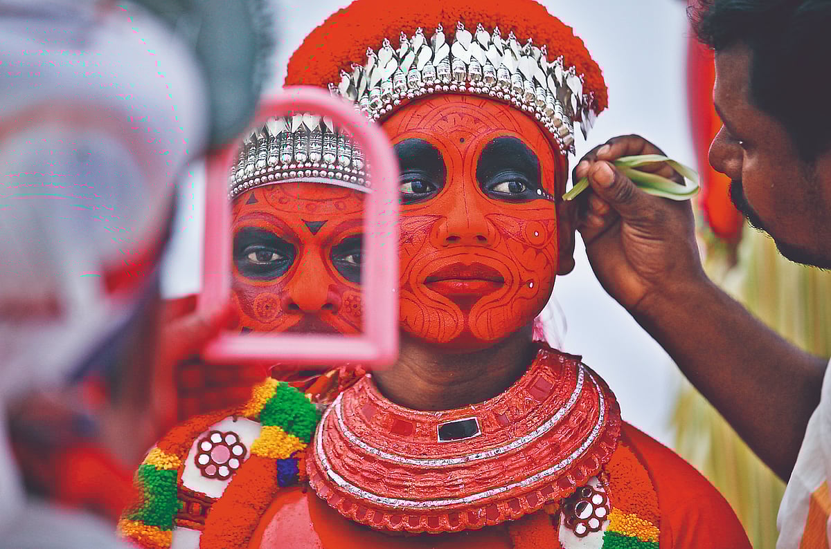 Theyyam dancer getting ready for Onam celebrations
