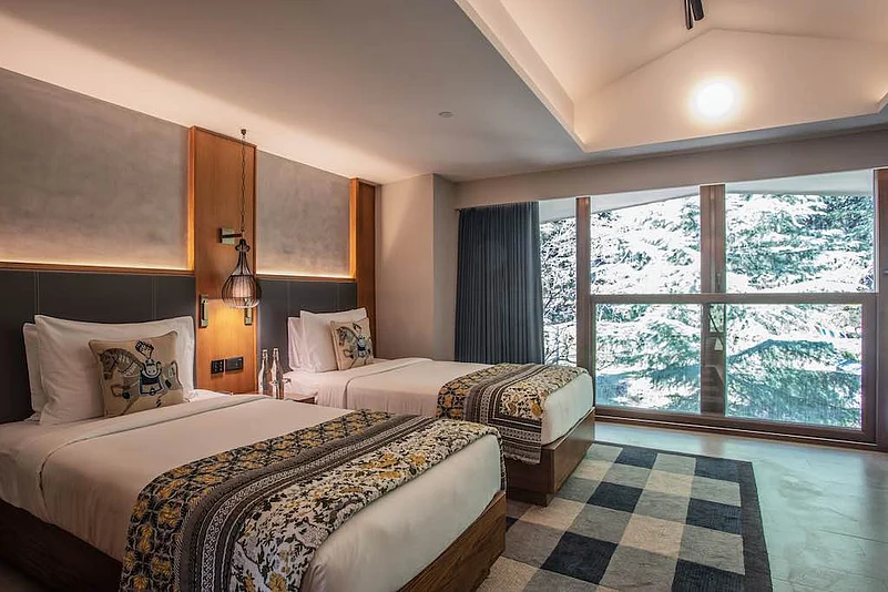 The mesh door of the hotel room gives a stunning view of the blue mountain.