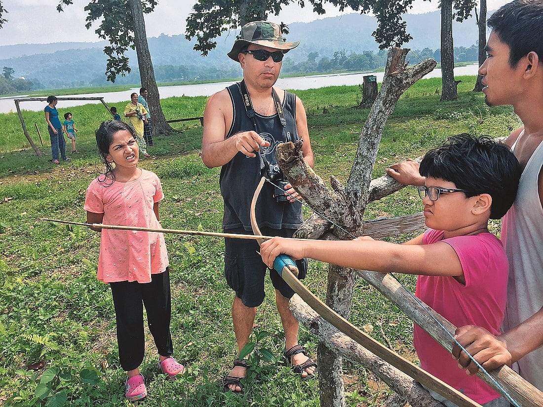 Learning how to use a bow near Assams Chandubi Lake