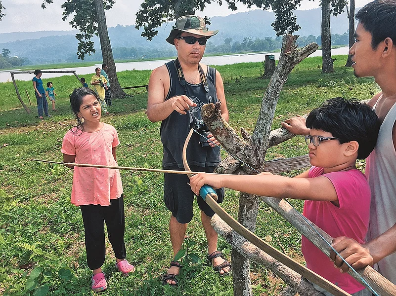 Learning how to use a bow near Assams Chandubi Lake