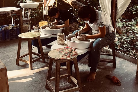 People trying their hands at pottery