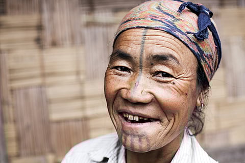 An Apatani woman with a tattooed face