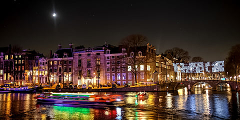Light installations brighten up Amsterdam's quaint, snow-sprinkled canals