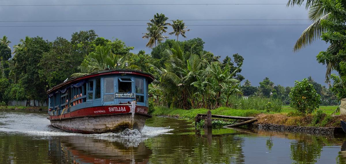 A boat plying at the Alleppey backwaters