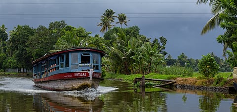 A boat plying at the Alleppey backwaters