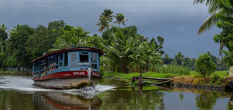 A boat plying at the Alleppey backwaters