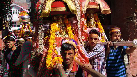 People carry the local deities on their shoulders on their way to Kullu