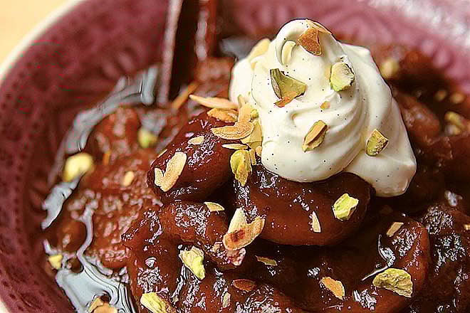 Moz ka meetha (mashed bananas cooked in sugar syrup and garnished with mixed nuts and cream