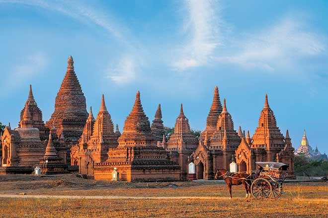 A horse cart at sunrise in front of the Temples of Old Bagan